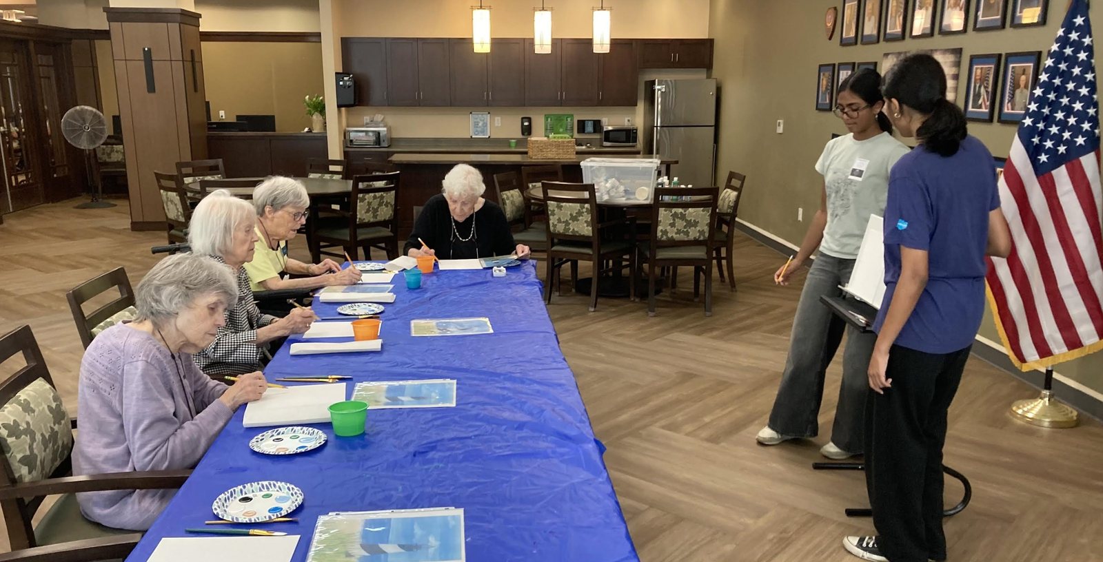 CARES officers walking around the room to help residents paint