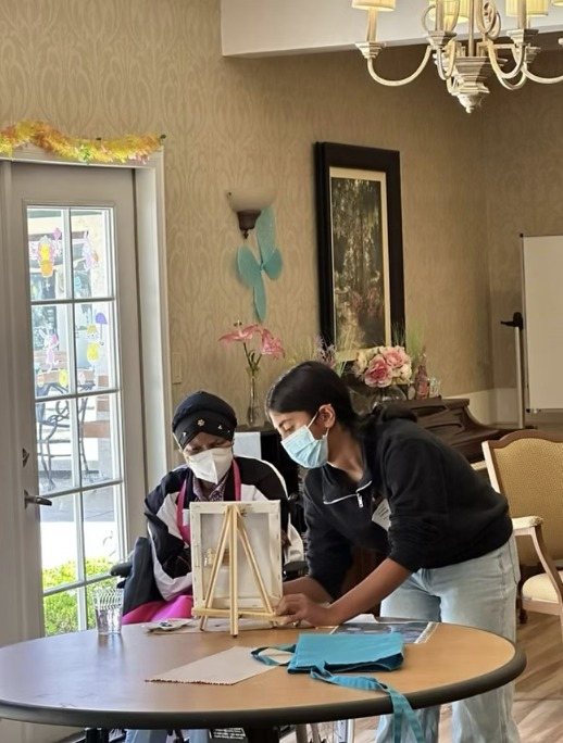 A CARES officer helping a resident at an easel