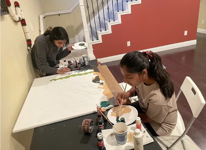 CARES officers painting at a table