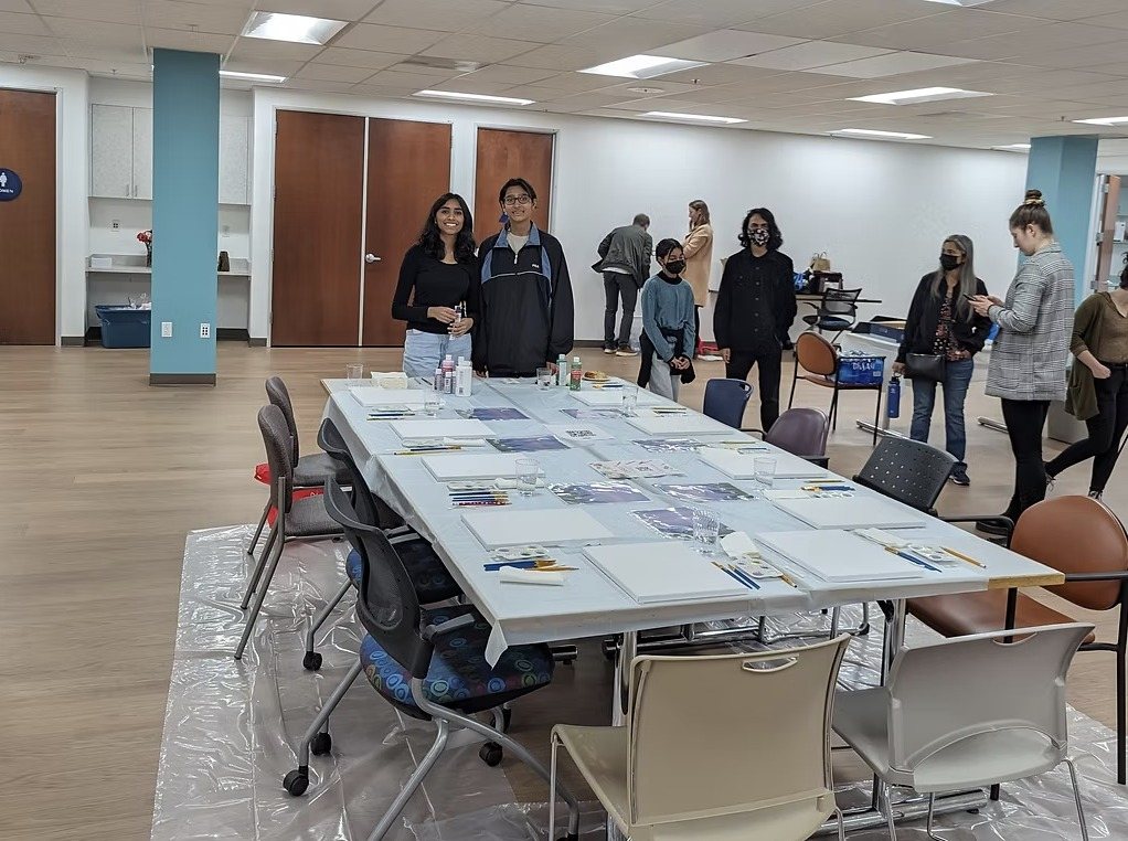 The art fundraiser room with a long table set up for painting